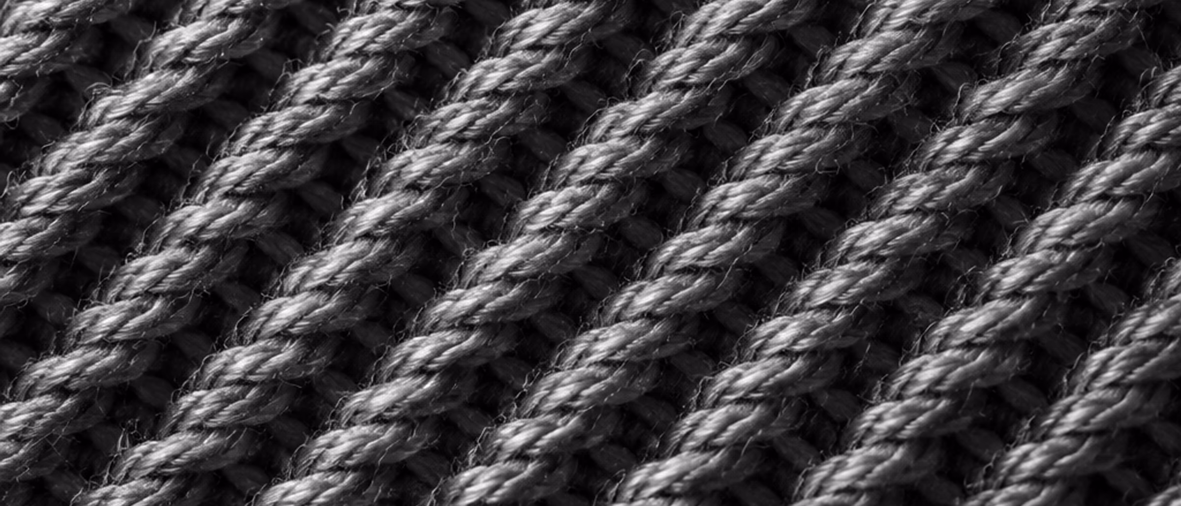 Black-and-white macro of a twill fabric weave