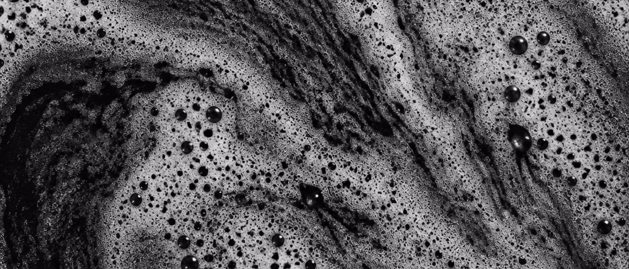 Black-and-white macro of the crema on an espresso