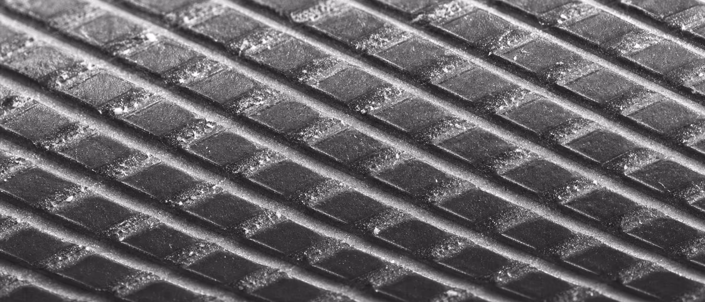 Black-and-white macro of barbell knurling